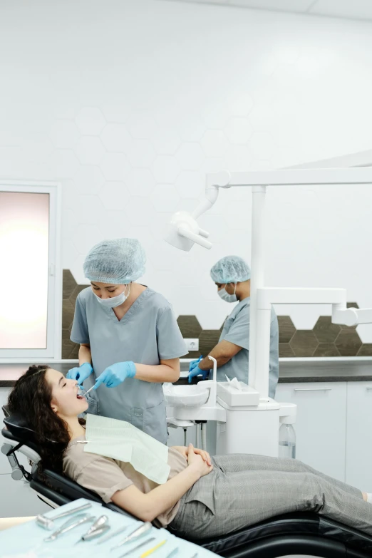 a dentist attending to a patient with her eyes open