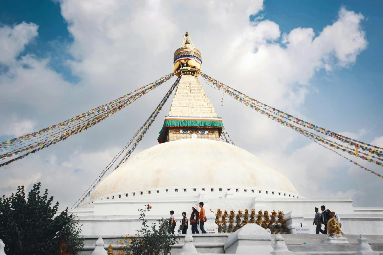 a buddhist pagoda sits in the middle of a field