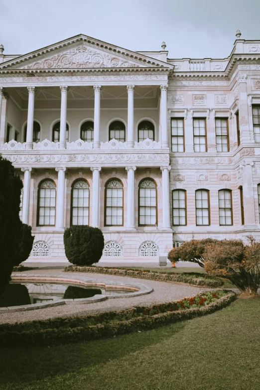 the side view of a large palace building with a circular garden