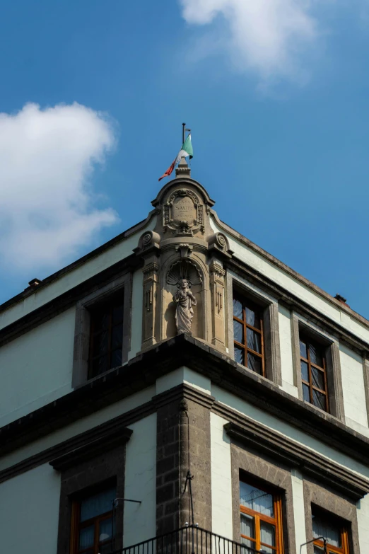 a tall white building with a steeple in front of it