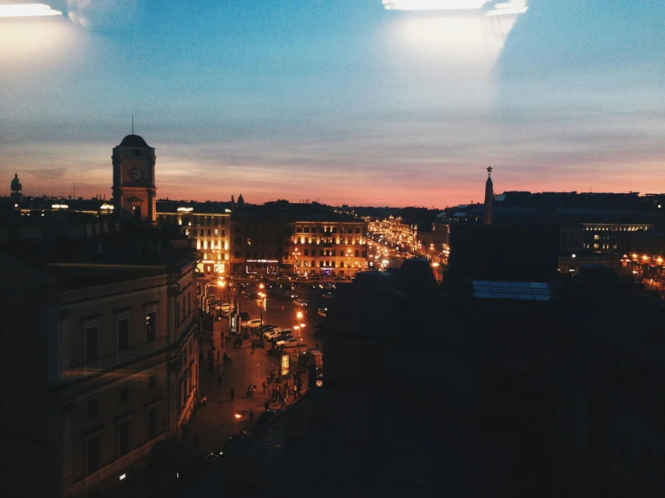 the city is lit up at night with the street lights