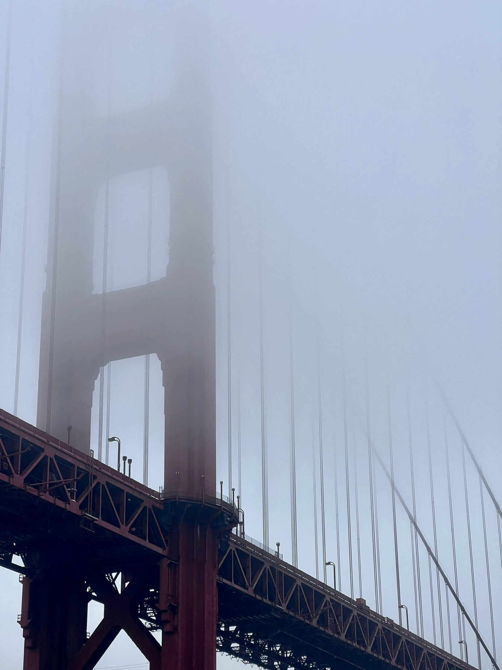 a large bridge with fog around it