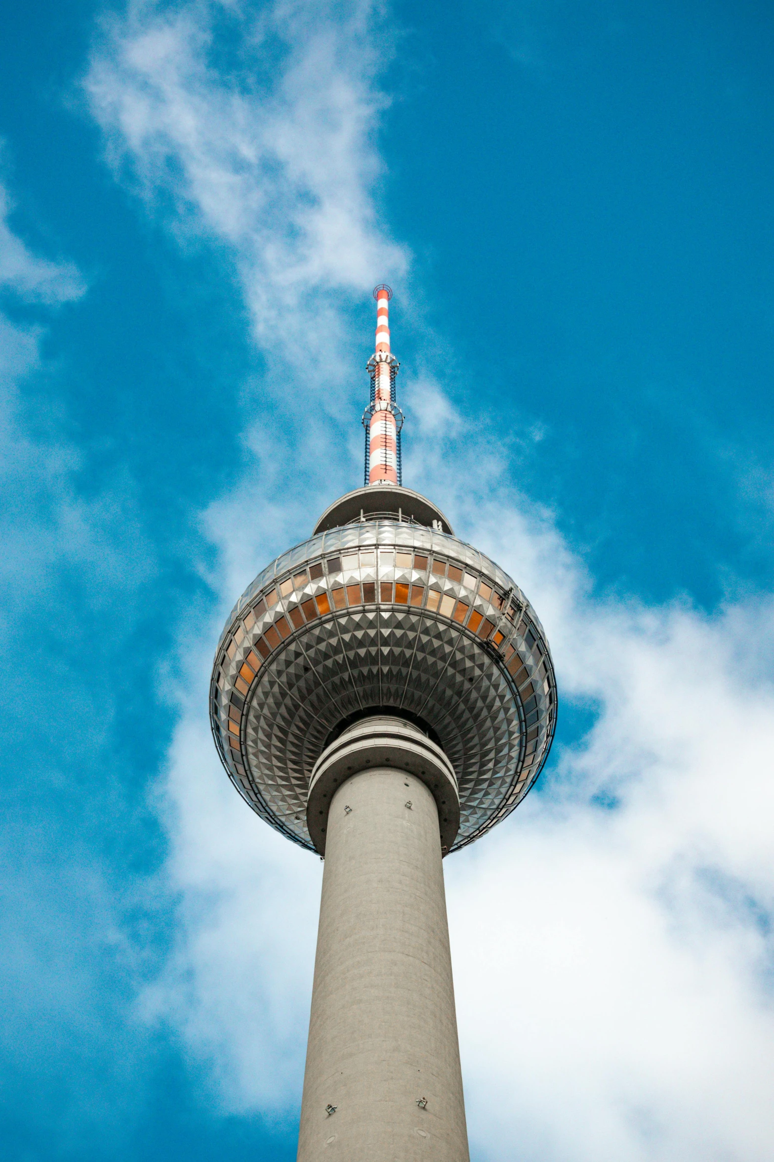 the top of a tall building with a clock on it's face