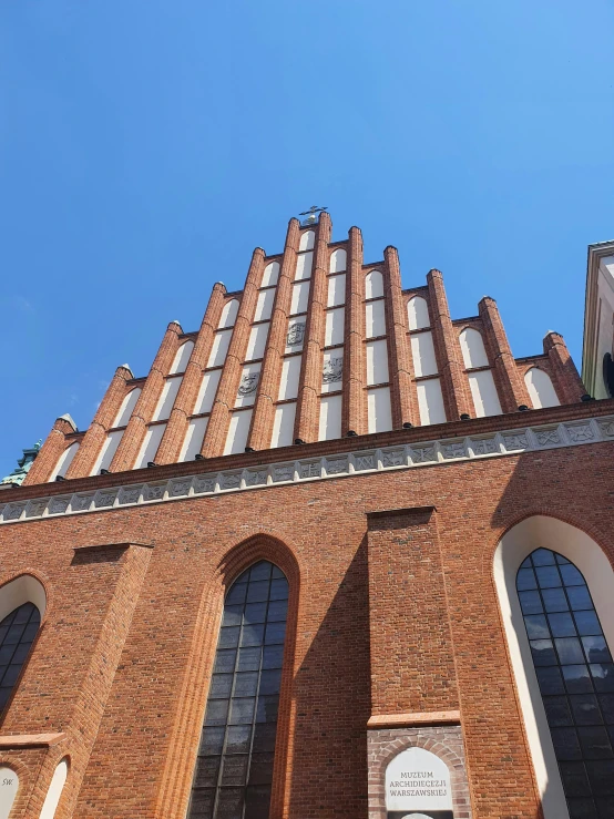 looking up at an old brick building with windows