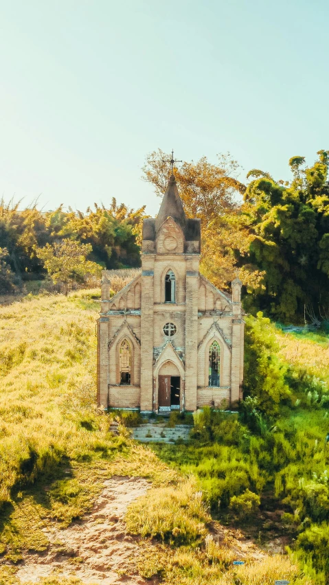 an old church in the middle of a field