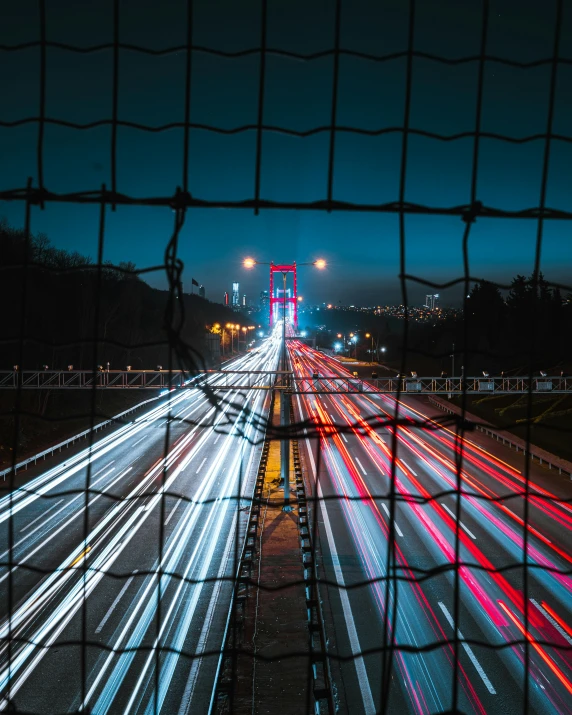 a city highway filled with lots of traffic at night