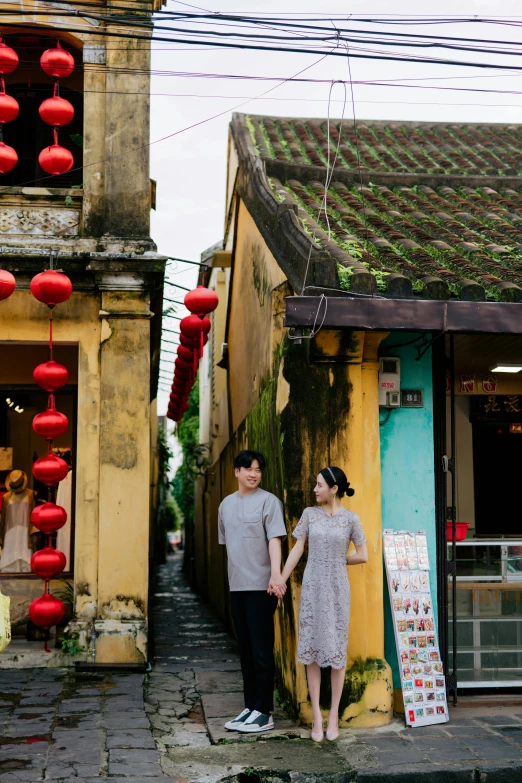 two people standing next to each other on the street