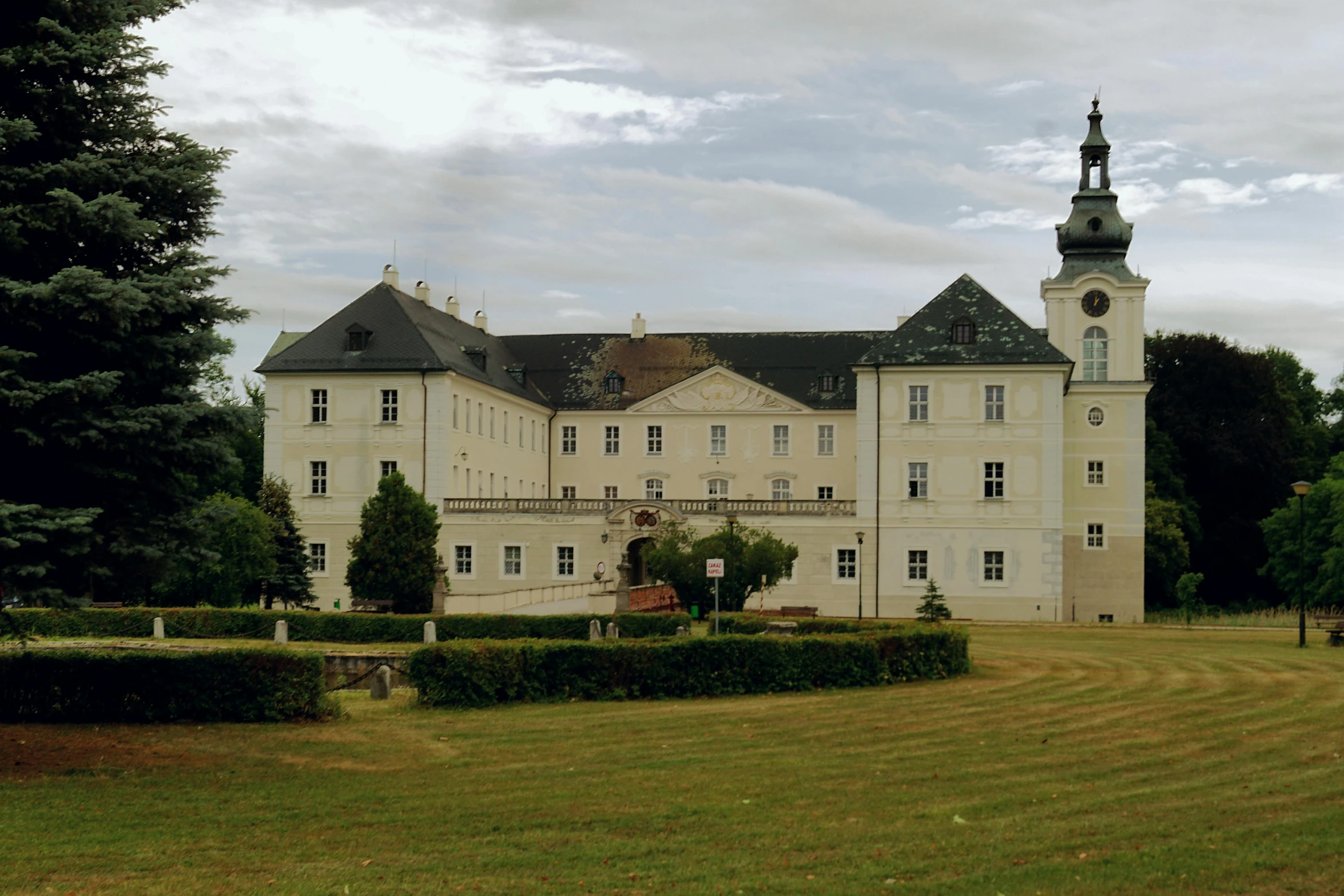 large building sitting on the grass near trees