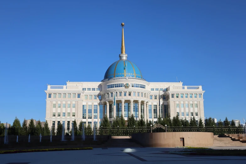 an old white building has a blue dome