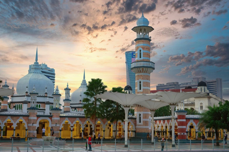 a small clock tower sits in front of a colorful cityscape