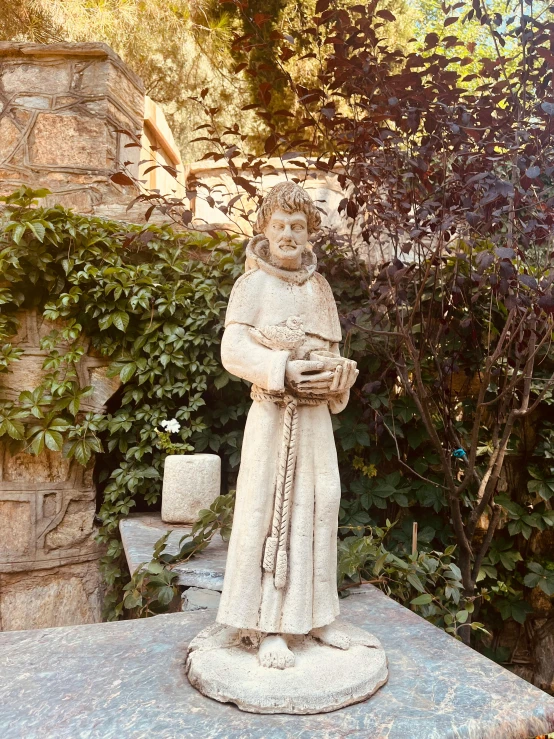 a statue stands on top of a rock