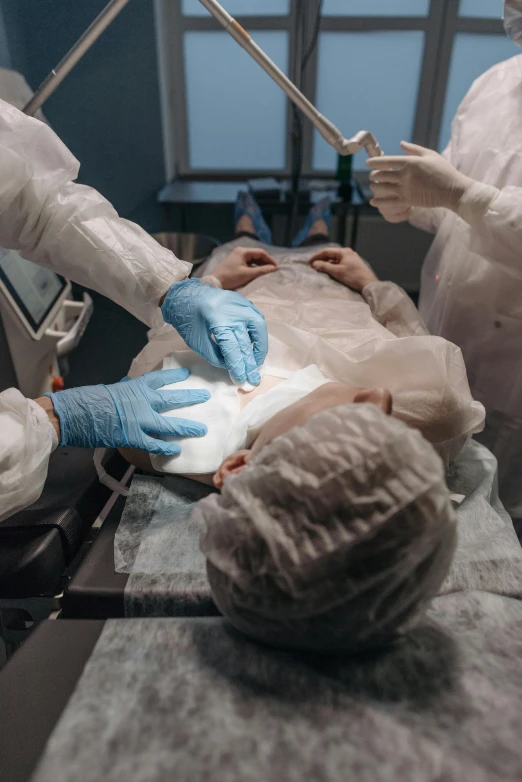 a surgeon using surgical equipment to check on a patient