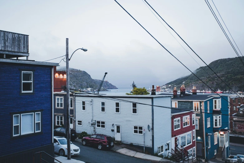 the blue house is near a very small street