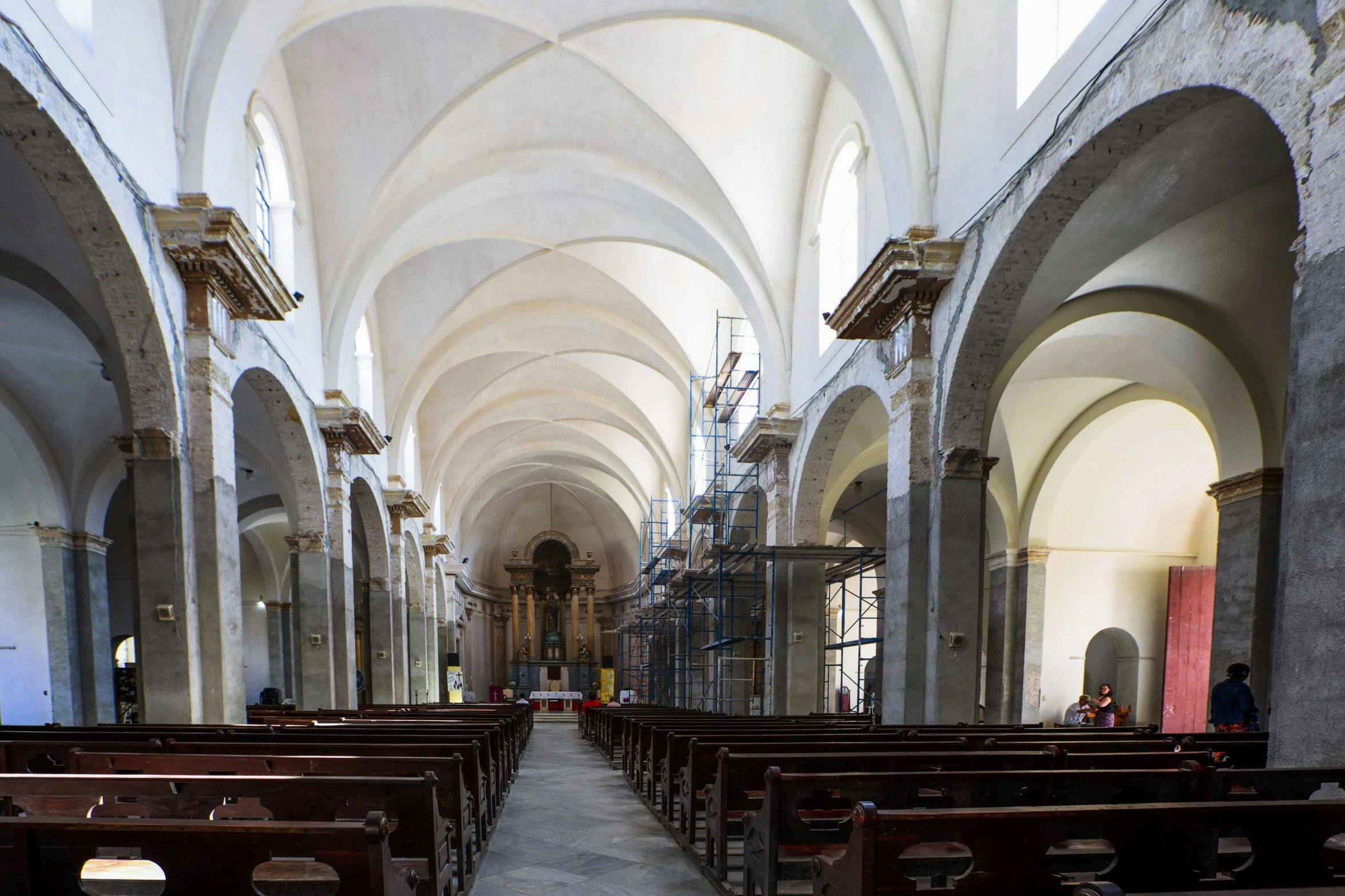 a church with high vaulted ceilings and stone pews