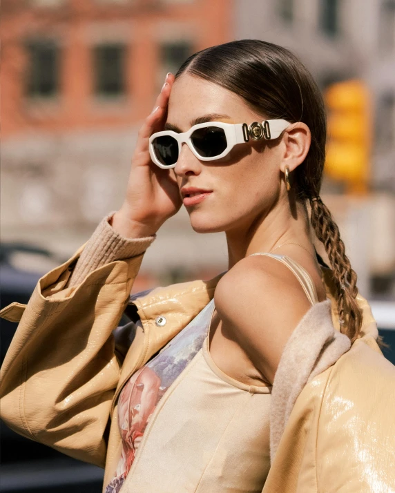 a woman in a crop top wearing sunglasses