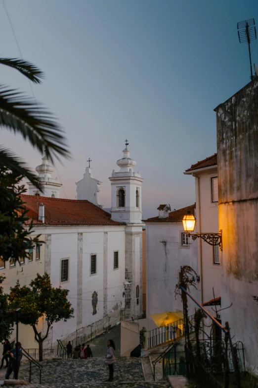 some people are walking down the steps next to a church