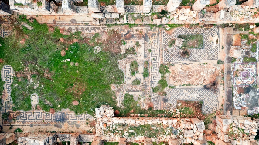 top down s of a grassy area with ruins in the background