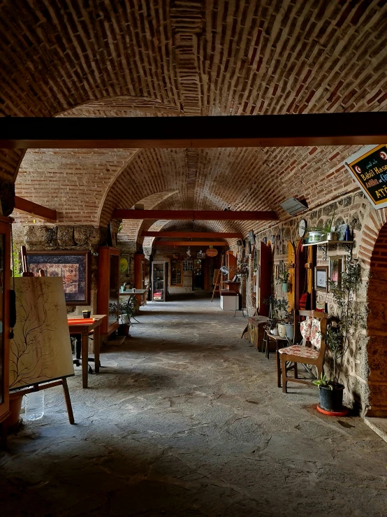 an arched walkway is full of antiques to be displayed