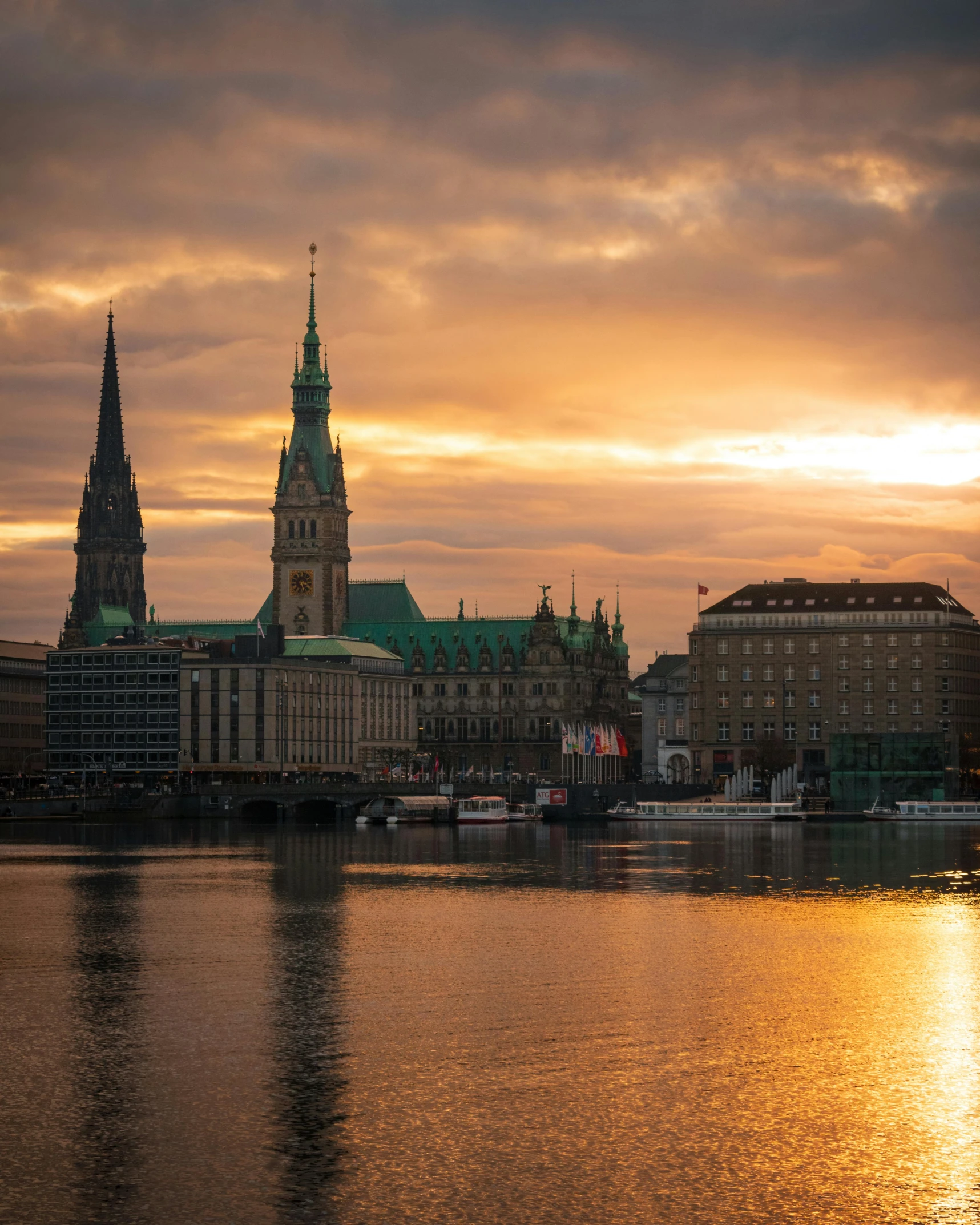 a body of water at sunset with buildings