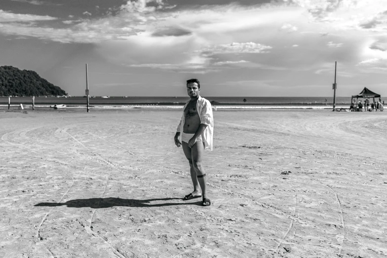 a person in the middle of the beach with no shoes