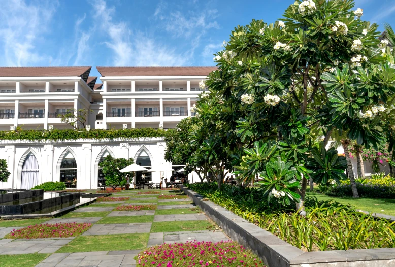 a beautiful resort resort is set with white flowers and trees