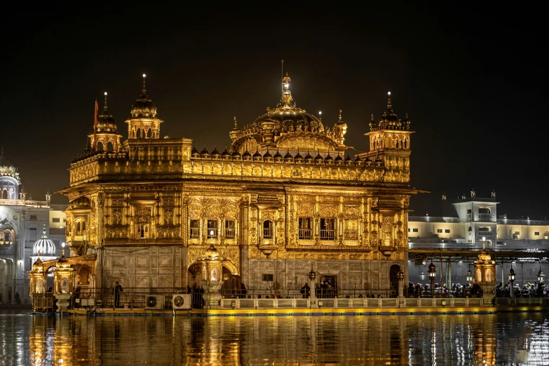 a building at night near the water's edge