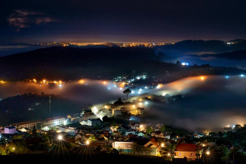 a night view with light fog hovering around the valley