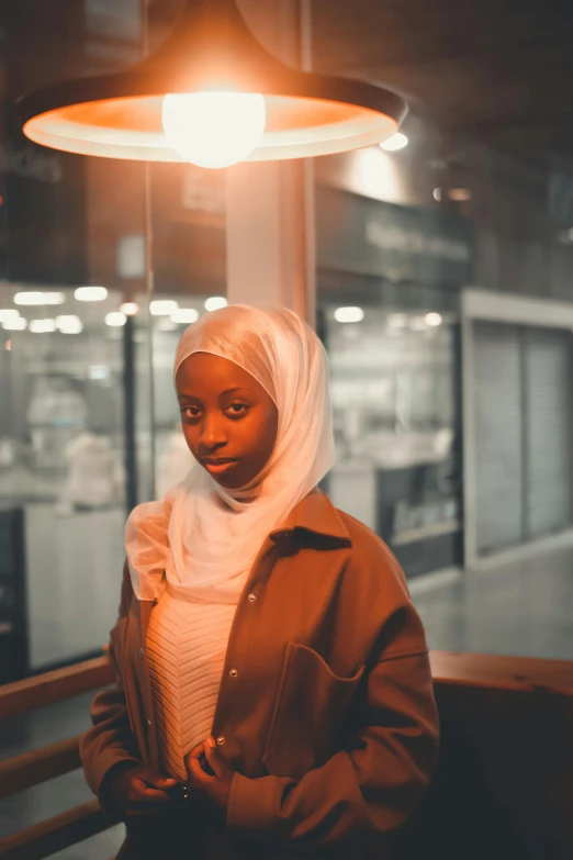 a beautiful woman standing under a bright light