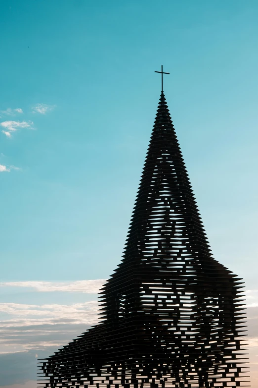 a tall spire that is very odd with small crosses on top