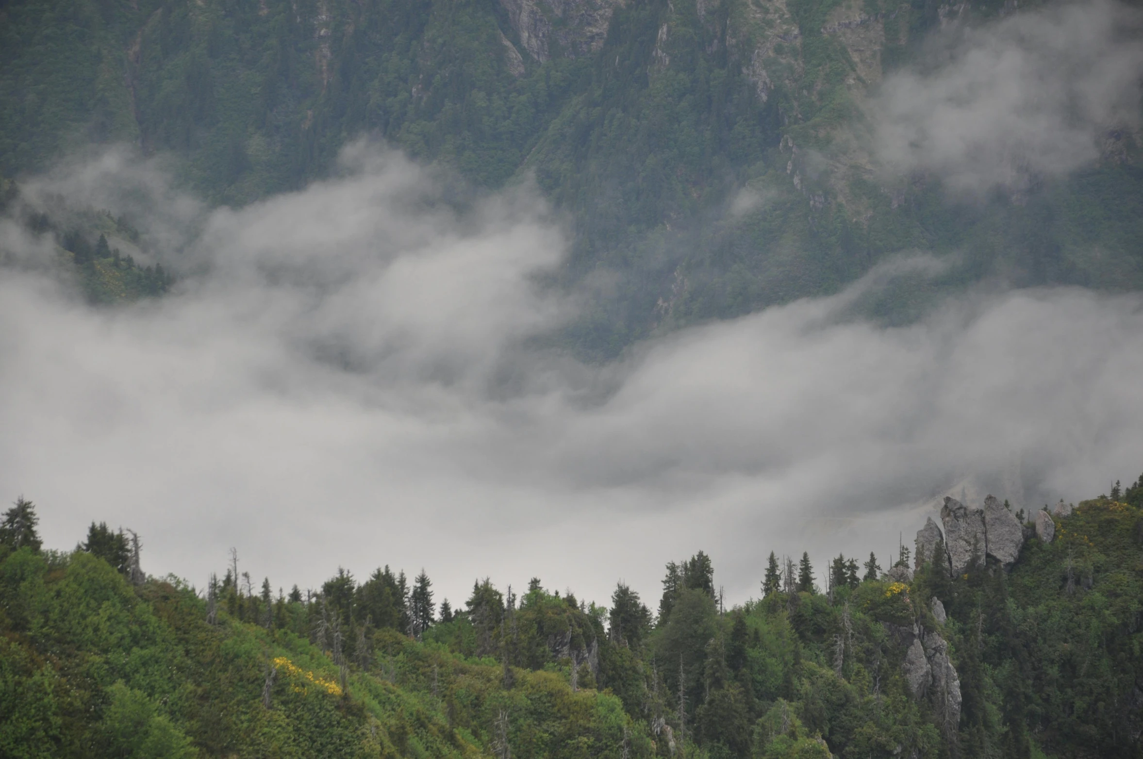 an airplane flying in the sky over some mountains