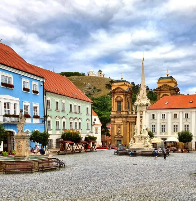 a few buildings are in a cobblestone road