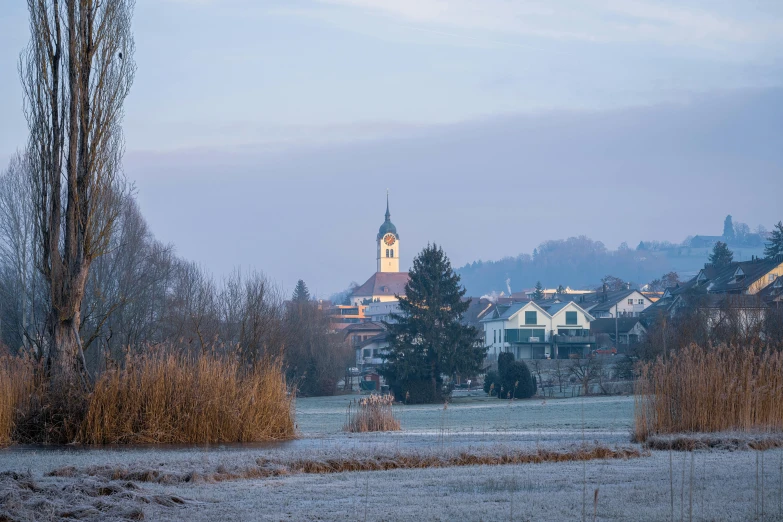 a foggy, snow covered town in the distance