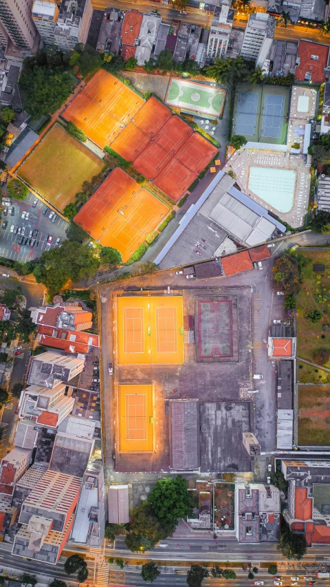 a parking lot with lots of tennis courts next to buildings