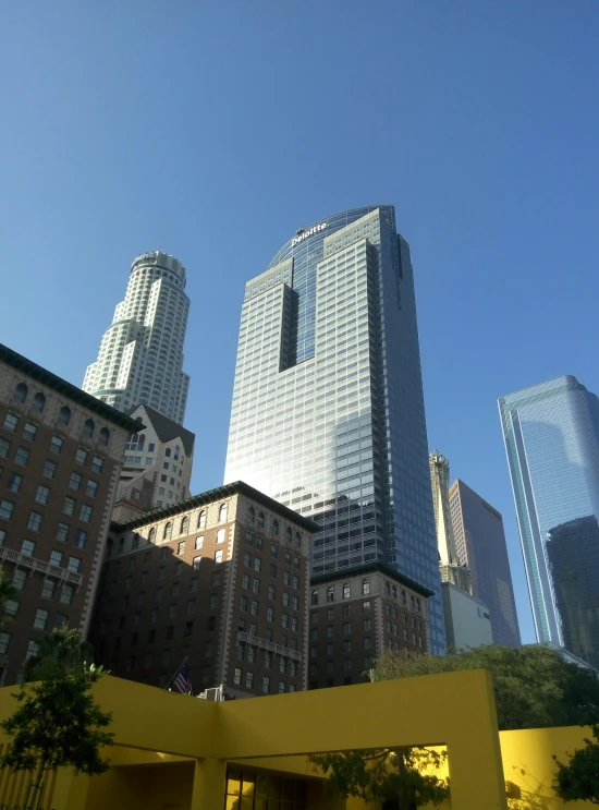 a view of buildings from the ground level in a city