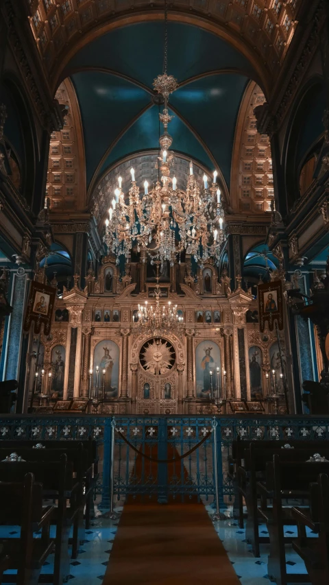 the inside of an ornate building with chandeliers and lights