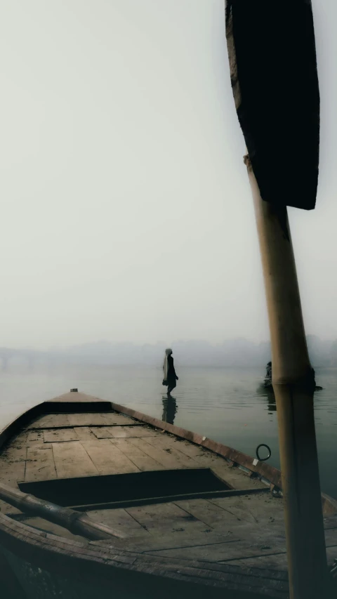 a man is wading down in a large boat