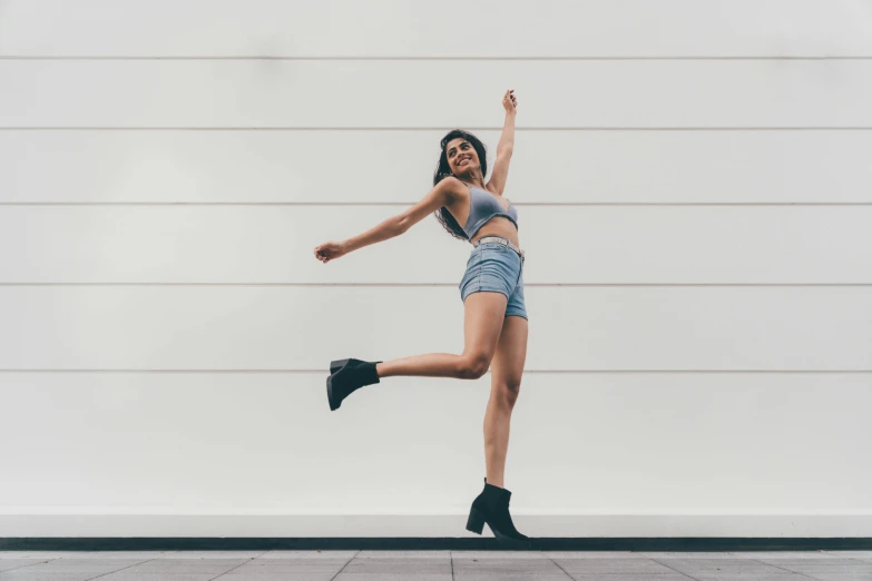 a girl standing in the air and stretching