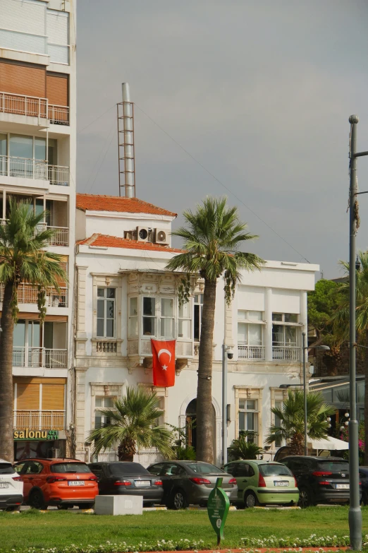 an apartment building on a small city street with a red traffic light on the corner