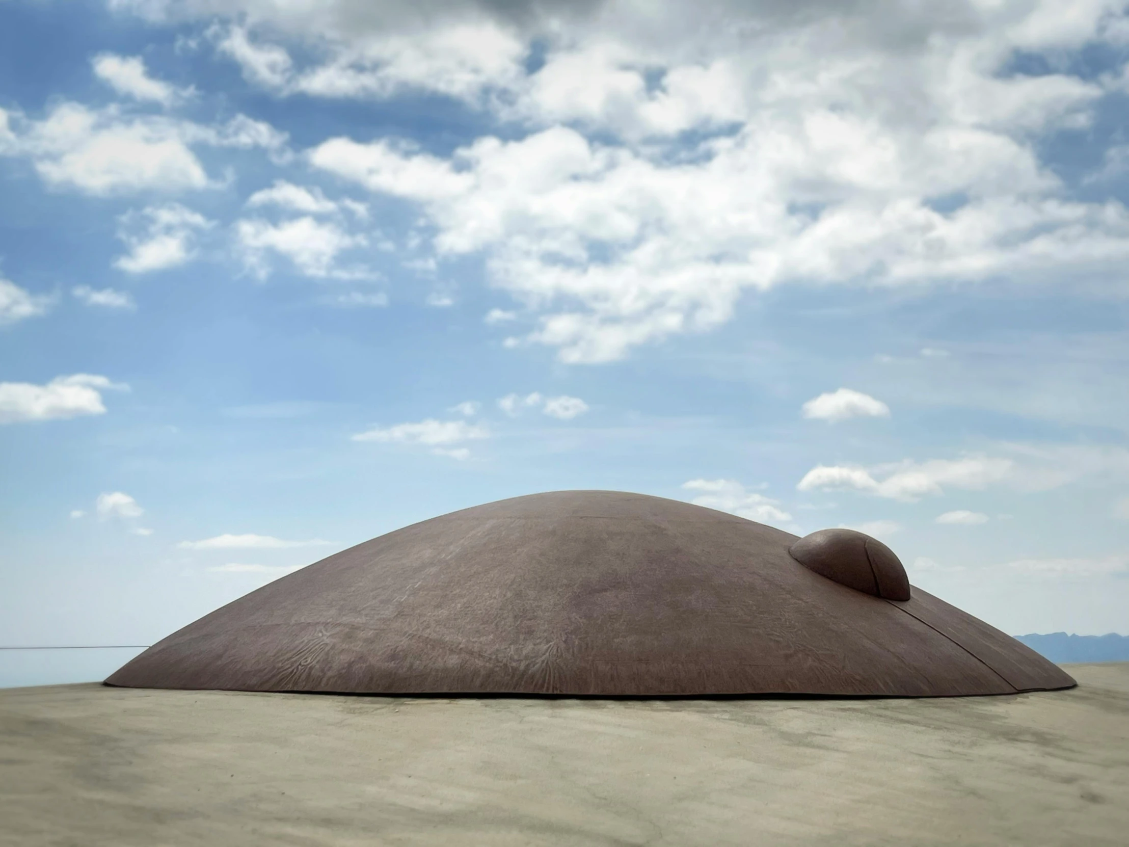 the large boulder sits on top of the sandy shore