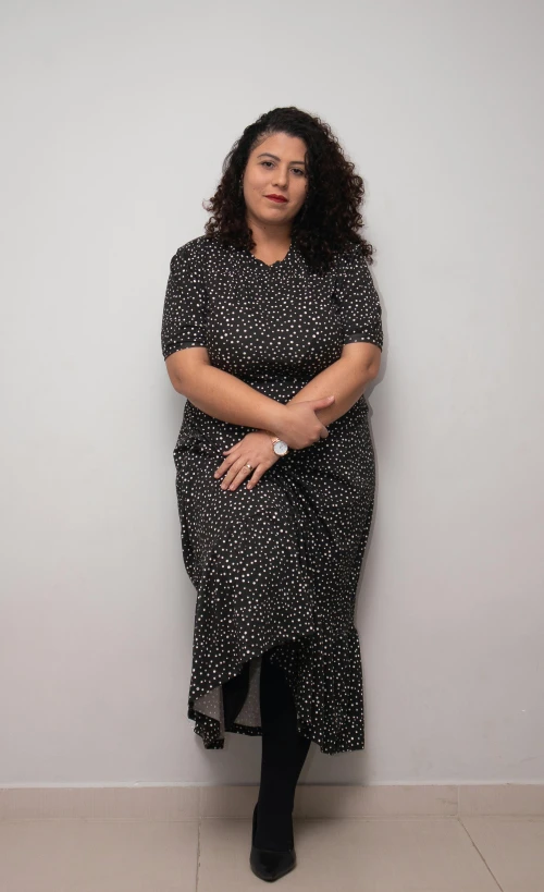 an older woman is posing with her arms folded