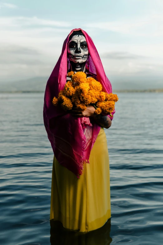 a person in a costume and holding flowers