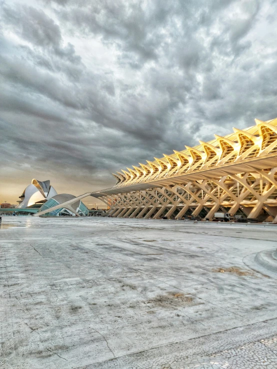 a row of large structures sitting on top of a sandy beach