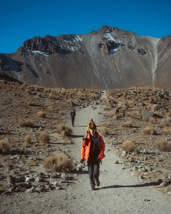 people with packs are hiking in the mountains