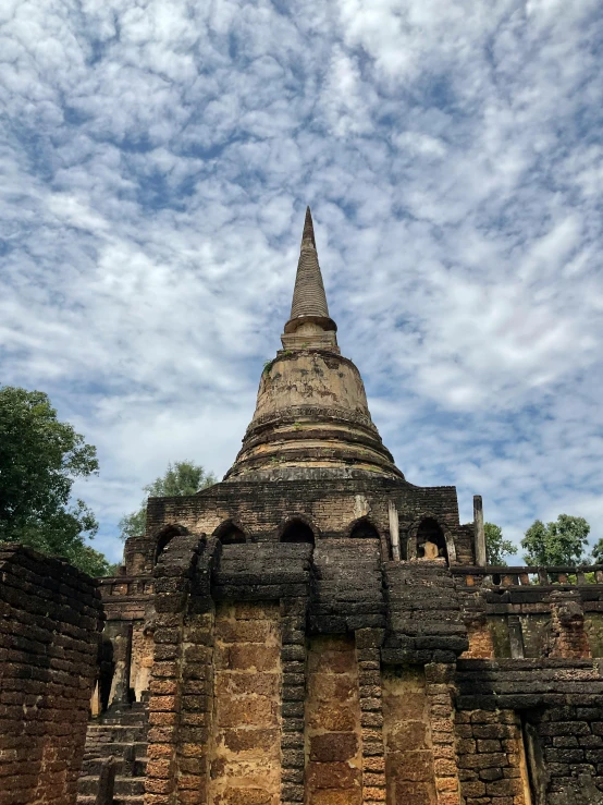 a very large stone tower sitting under a blue sky