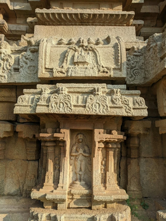 carved rock sculpture with woman, animals and other ornaments