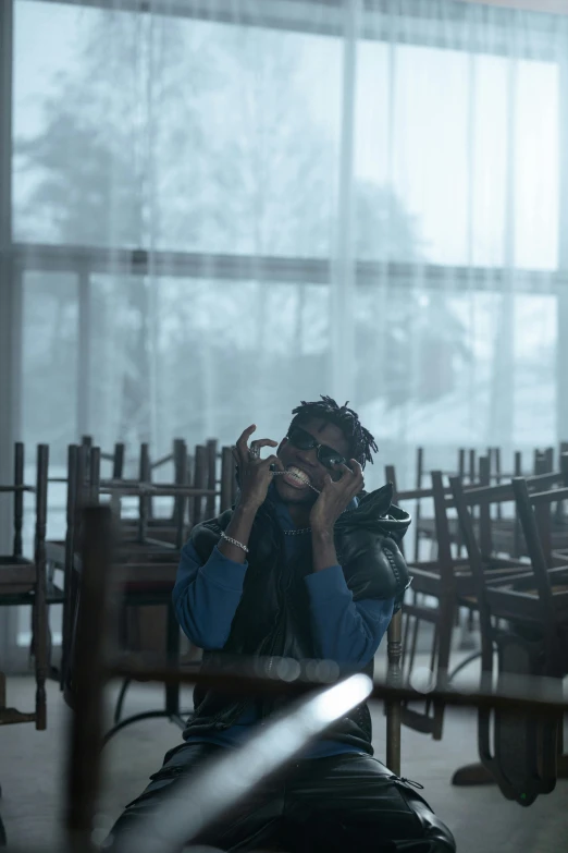 a person sitting in a room with many chairs