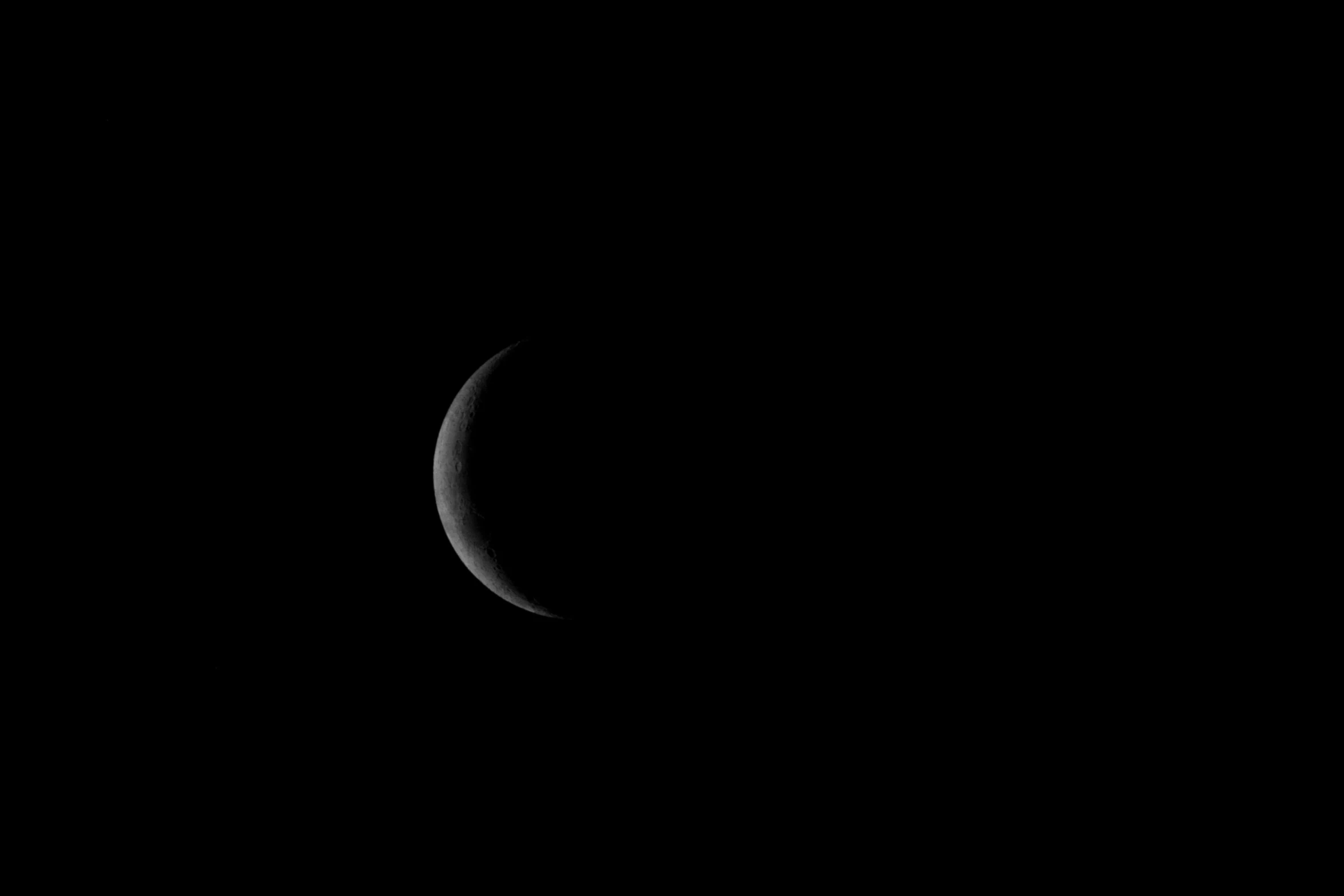 a crescent in the sky with a black background