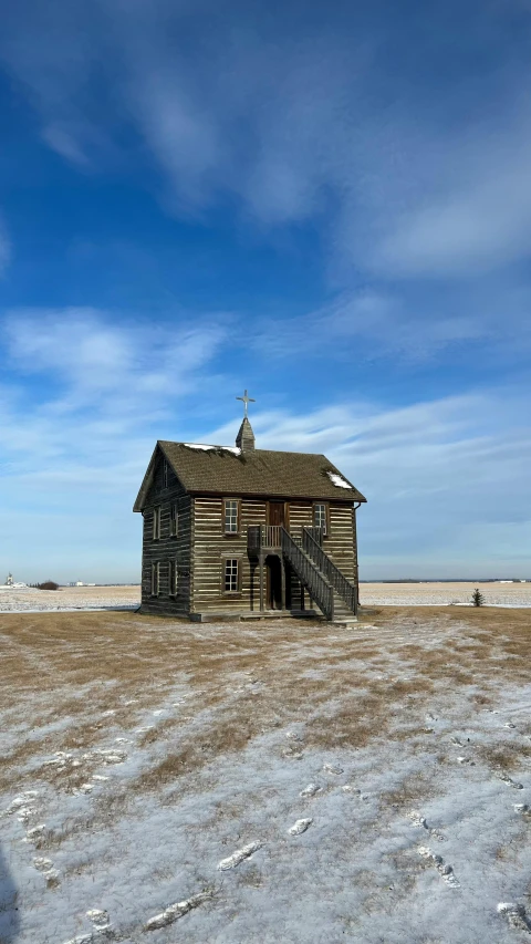 a large old barn that is standing in the middle of the field