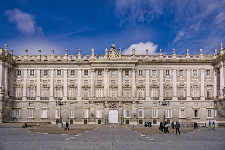 a very big building with some people near by