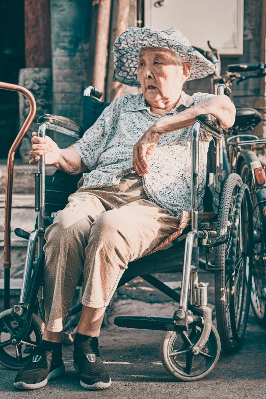 a old lady in a wheelchair with a hat